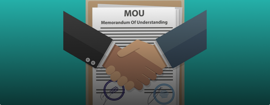 A picture of hands shaking hands and a memorandum in the background